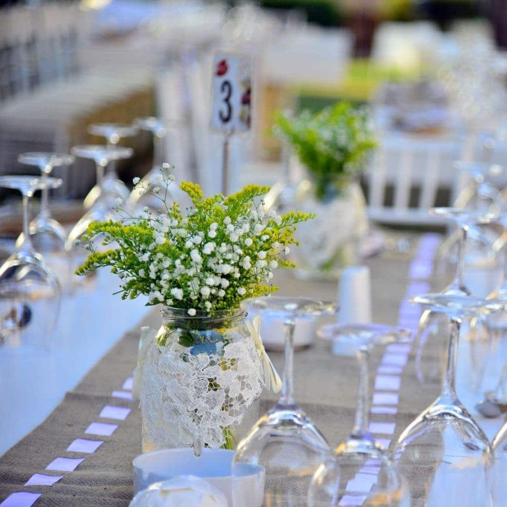 a vase with a flower arranged in a table top