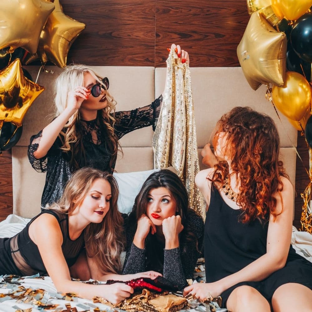 4 girls preparing for a perty inside a bedroom